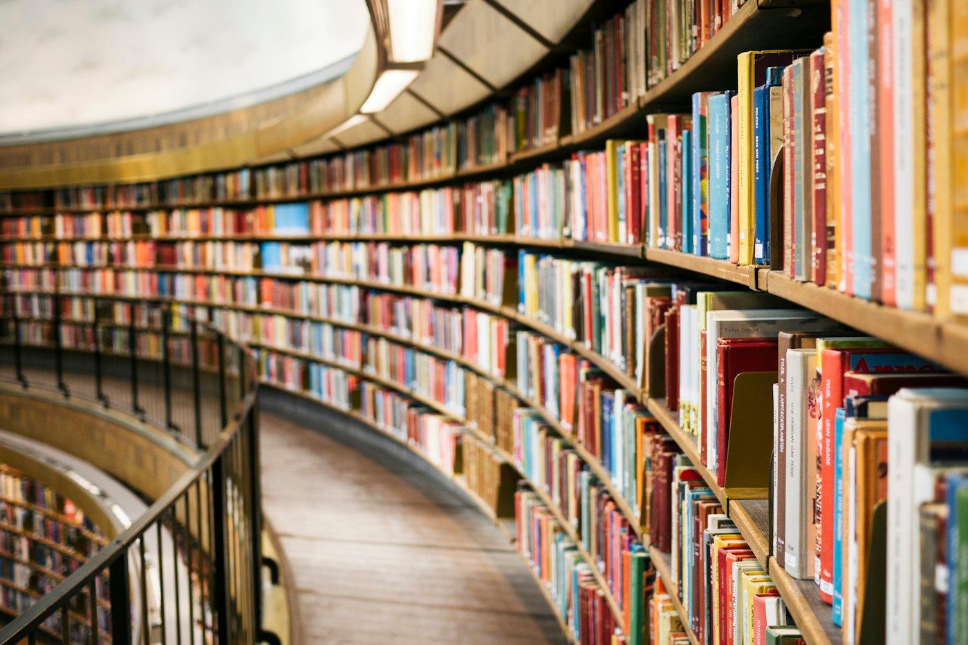 Curved library shelves filled with catalogued books