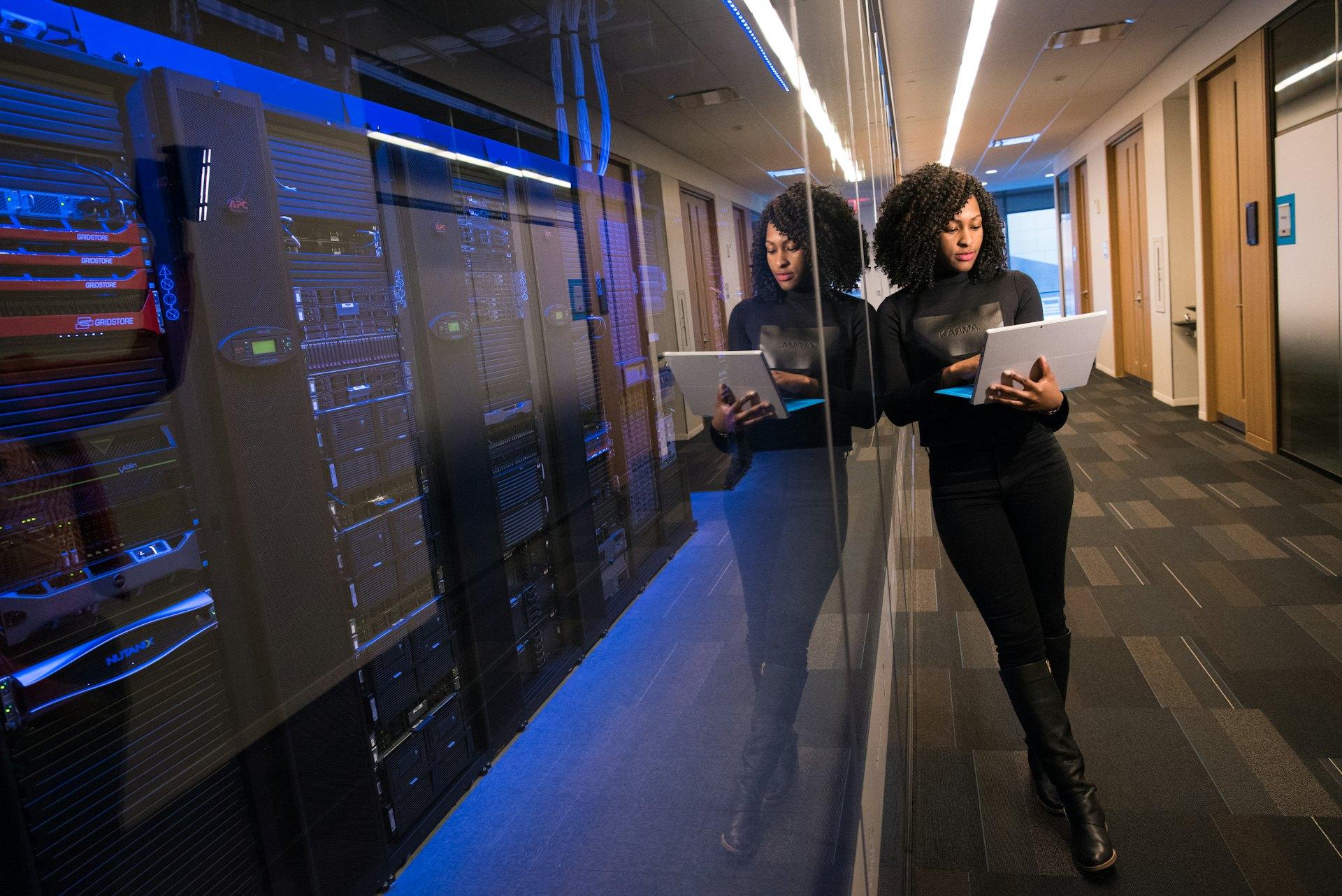 Engineer checking equipment in a data center aisle